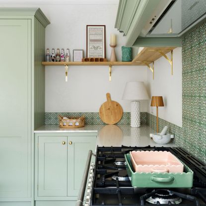 kitchen with green cabinets, patterned splashback and open shelving