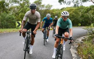 Four people cycling on road bikes