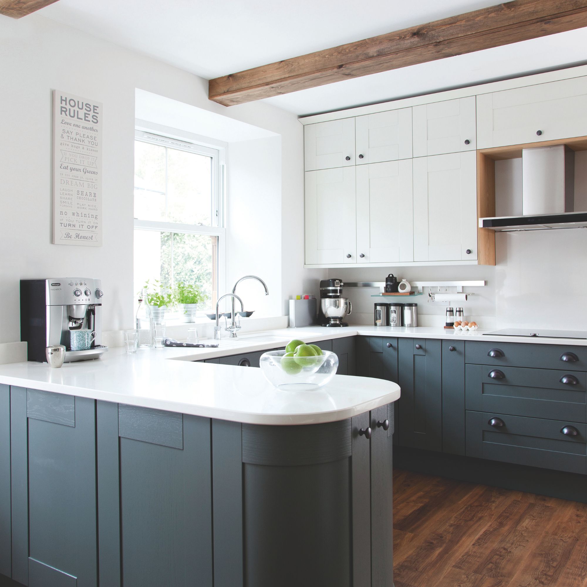 White kitchen with white countertops and dark blue cabinets