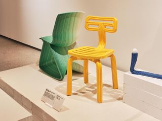 A green and a yellow chair, and a blue table lamp, made of recycled plastic
