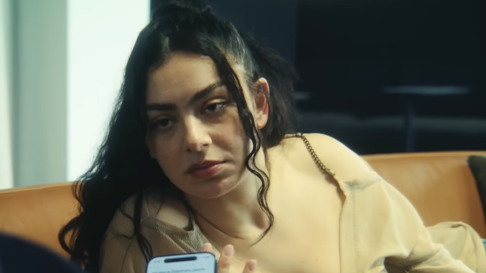 Charli XCX is shown in The Moment.