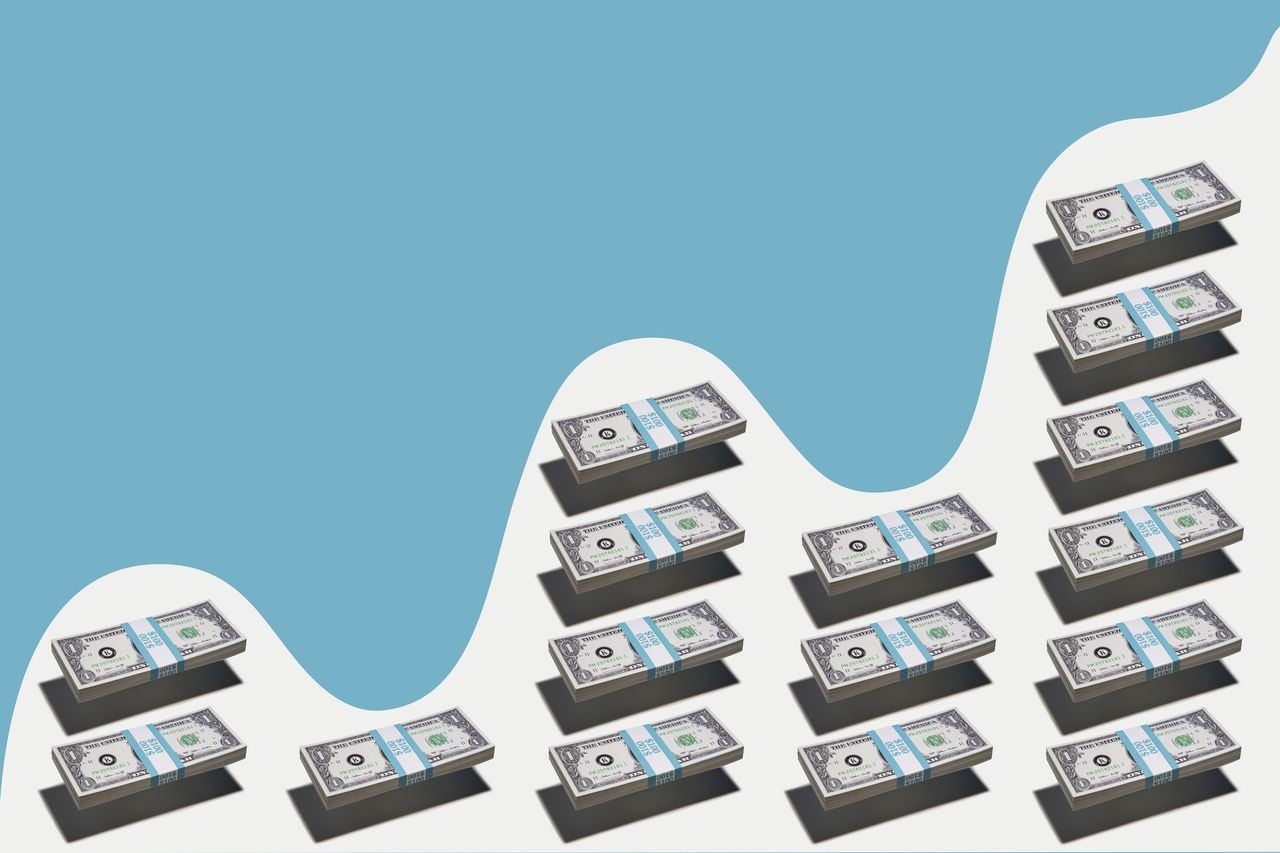 Bundles of money hovering over white surface in bar graph formation showing variable growth under blue wave pattern