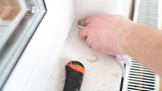 Removing caulk from around a window
