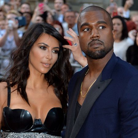 Kim Kardashian and Kanye West posing for crowd