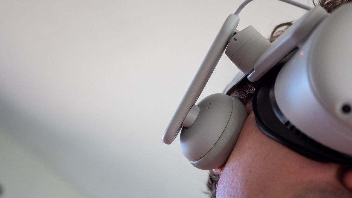 A close up of the headphones while wearing the Kiwi Design Comfort Battery Audio Strap for Meta Quest 2