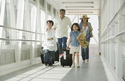 Family walking through airport