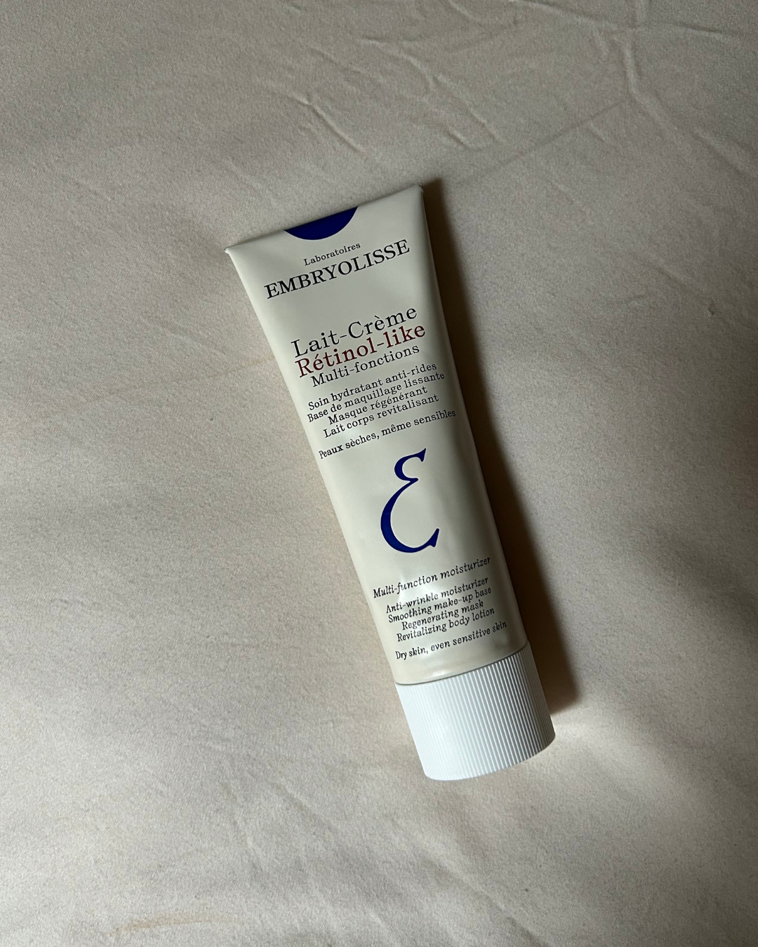Image of the Embryolisse Lait-Crème Rétinol-Like on a bed.