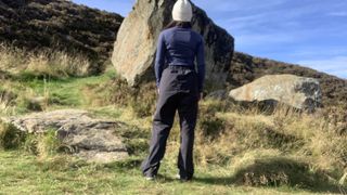 Hiker looking at large boulder