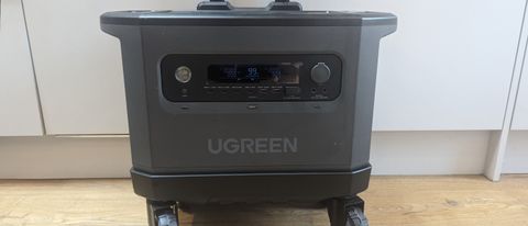 Ugreen PowerRoam 2200 power station on its wheeled stand on a wooden floor with a white cupboard backdrop