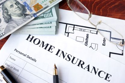 Home insurance policy on a wooden surface. 