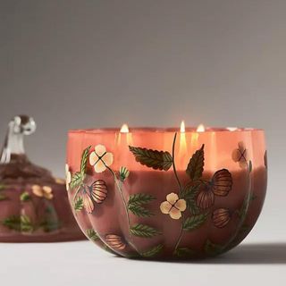 A painted pumpkin-shaped candle from Antrhopologie