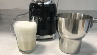 smeg milk frother with cappuccino milk and the jig in front