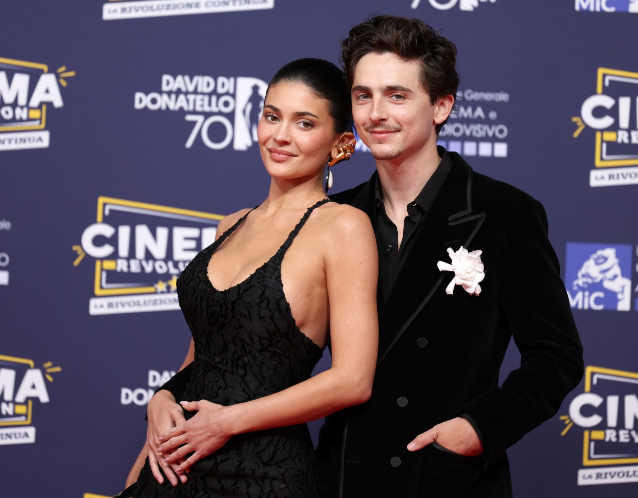 Timothée Chalamet and Kylie Jenner standing together, his left arm is around her hip, as they attend the red carpet during the 70th David Di Donatello at Cinecittà Studios on May 07, 2025 in Rome, Italy.