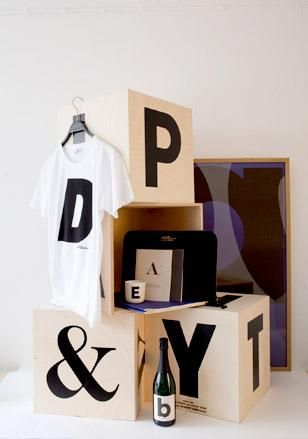 A stack of large boxes featuring large scale black lettering.