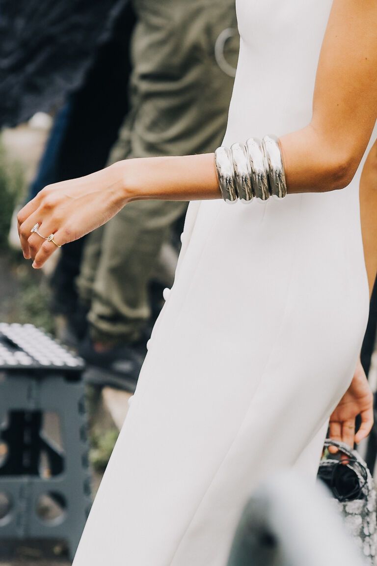women at fashion week wearing the summer jewelry trend 2026 of stacks of bangles on their wrists