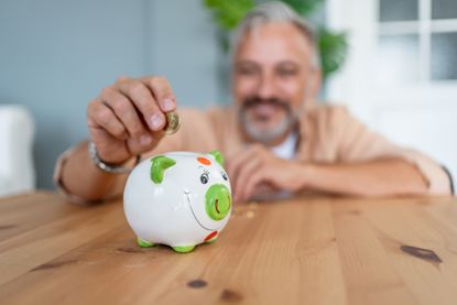Man inserting coins in a pension pot