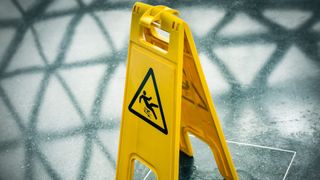 A slipping hazard sign on a wet floor