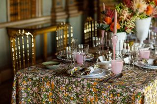Pretty marbled table linens on a dining table layered with an abundance of tableware and flowers