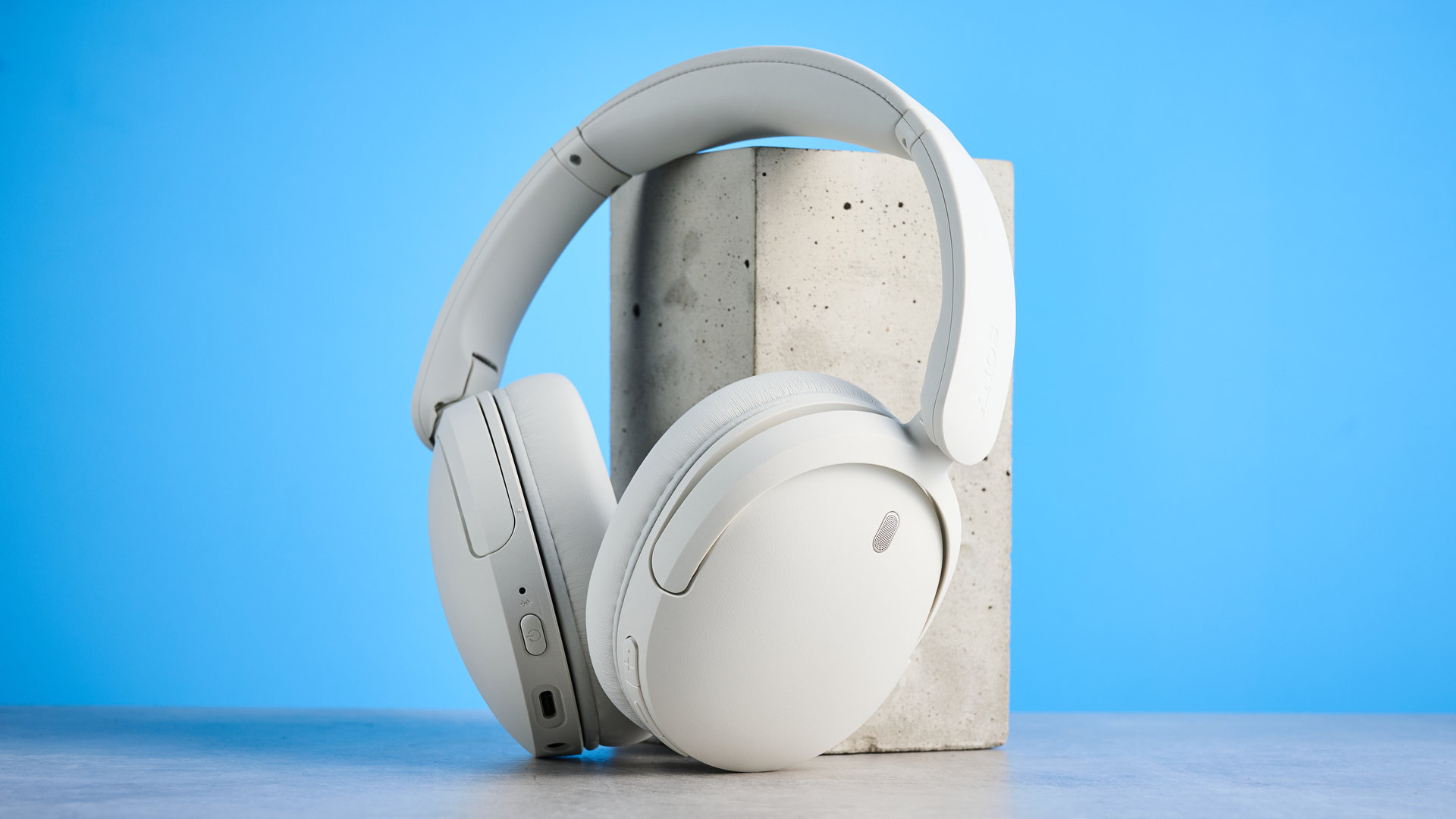 Sony WH-CH730N in white photographed in front of a blue background