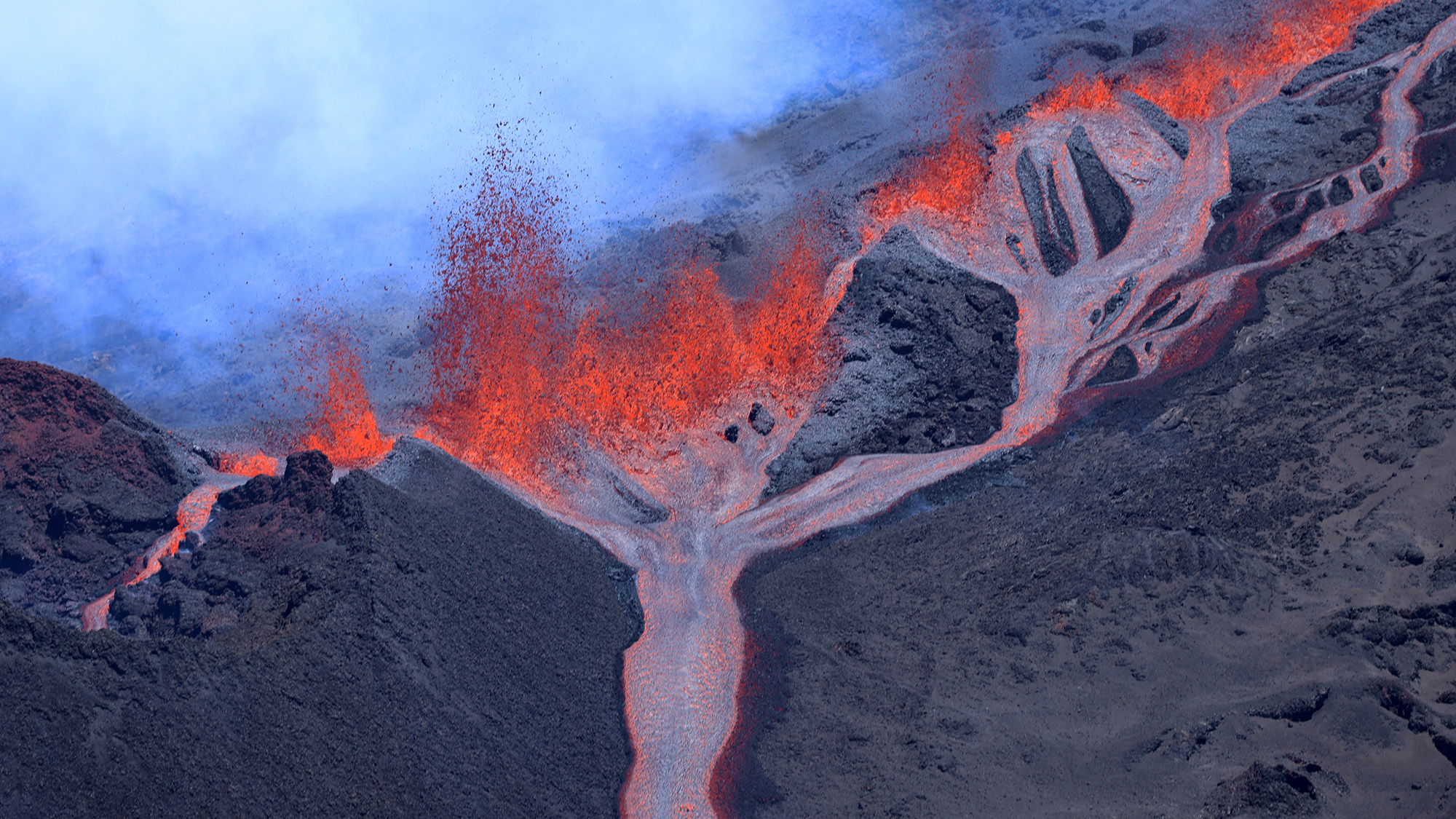 Smoke and lava erupts and flows from the Piton de la Fournaise volcano, La Reunion, French overseas territory