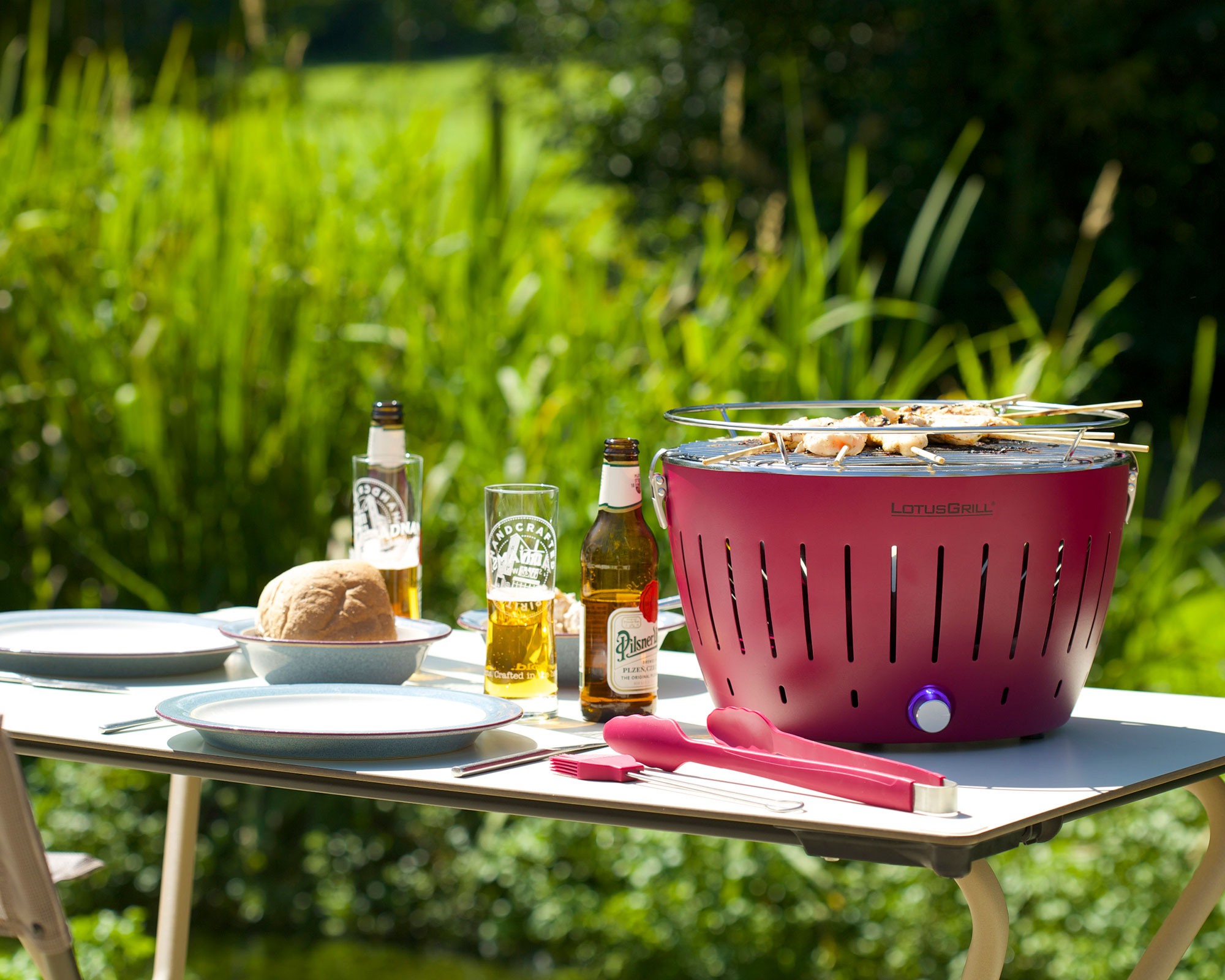 red tabletop BBQ on an outdoor table