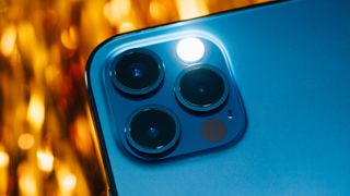 iPhone 13 Pro camera array with LED flash activated
