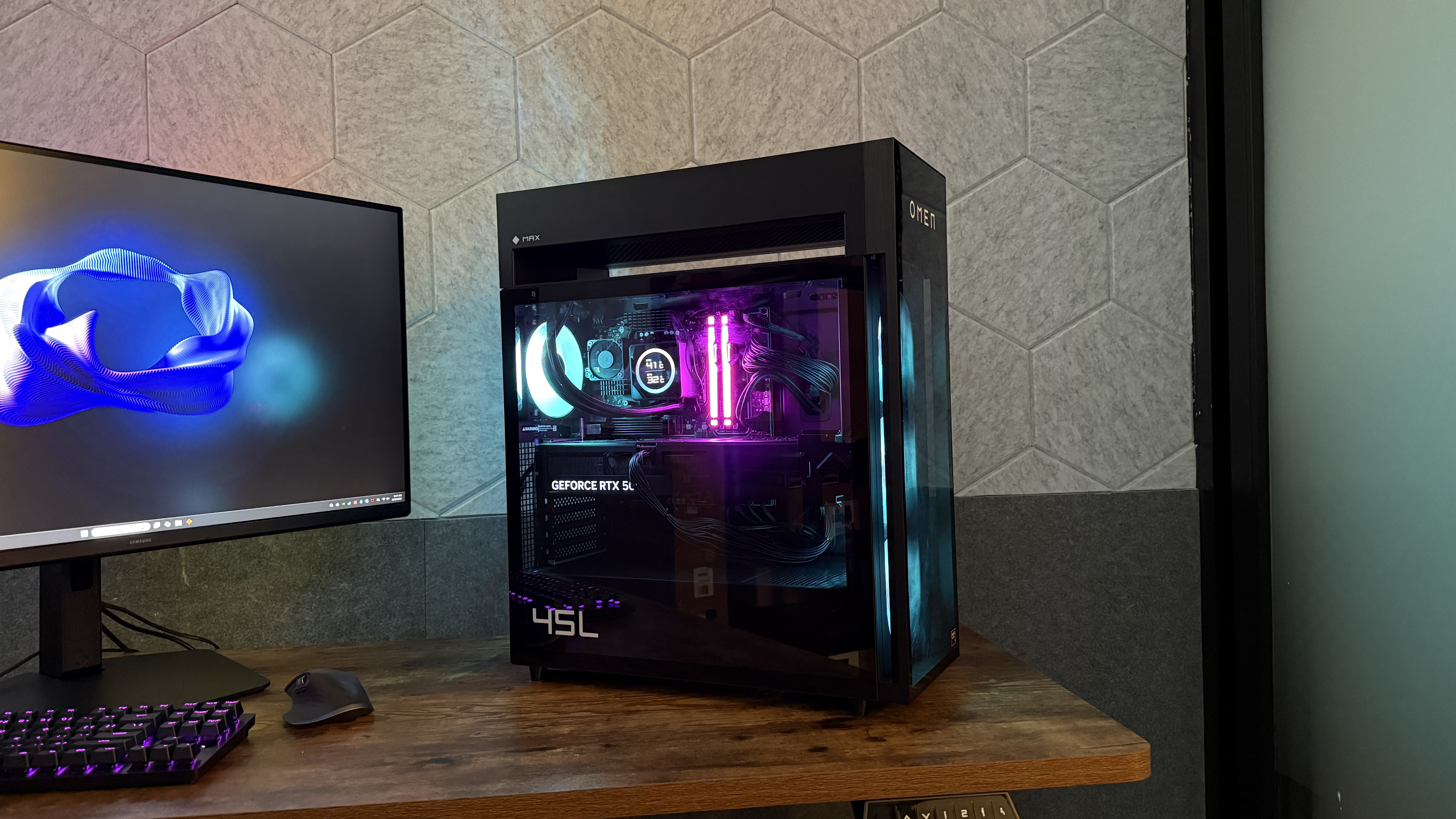 The HP Omen Max 45L on a desk with its RGB lighting enabled