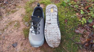 A pair of Fizik Terra Ergolace GTX Flat shoes with one showing the sole