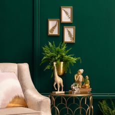 room with dark green walls and armchair