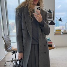 olympia gayot wears a grey jumper skirt and coat