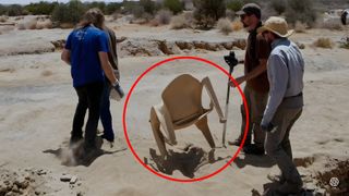 OpenAI prompt for Archeologists discover a generic plastic chair in the desert, excavating and dusting it with great care.