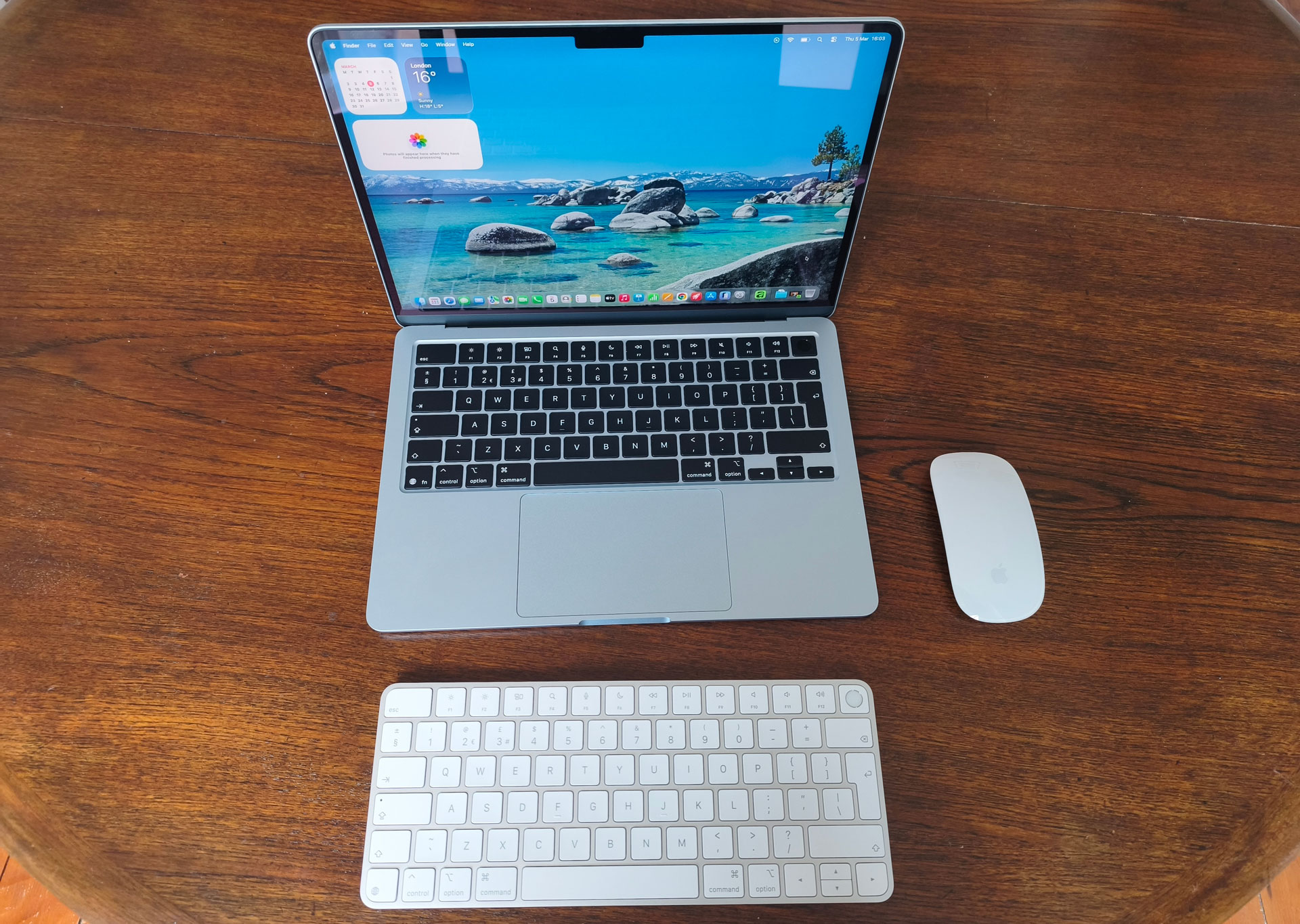 MacBook Air M5 on a table with a Magic Mouse and keyboard next to it