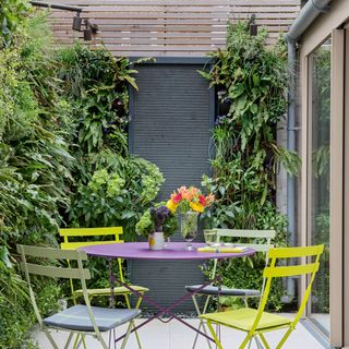 plant wall with rounded table and chair