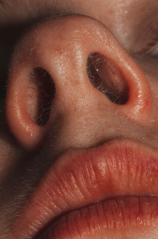 Close up shot from below of a person's nose and mouth in high definition