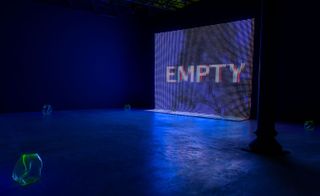 A blue screen saying Empty in an empty exhibition space