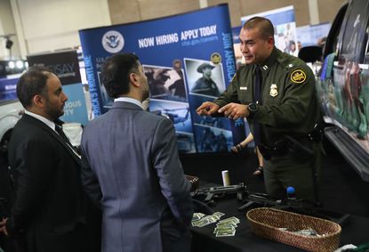 ICE agents pitch their job at a border security fair