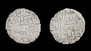 Two silver coins from the Islamic Era found behind a temple in Egypt.