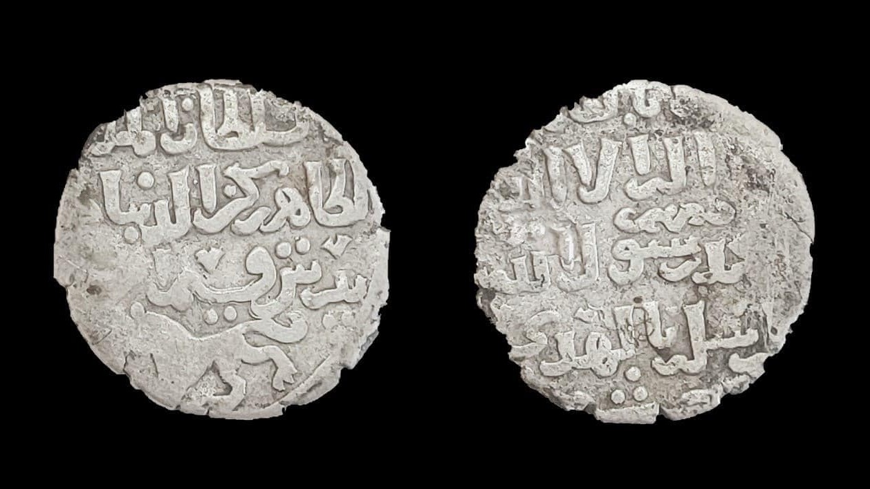 Two silver coins from the Islamic Era found behind a temple in Egypt.