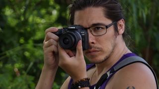 Canon EOS R10 held up to a man's eye