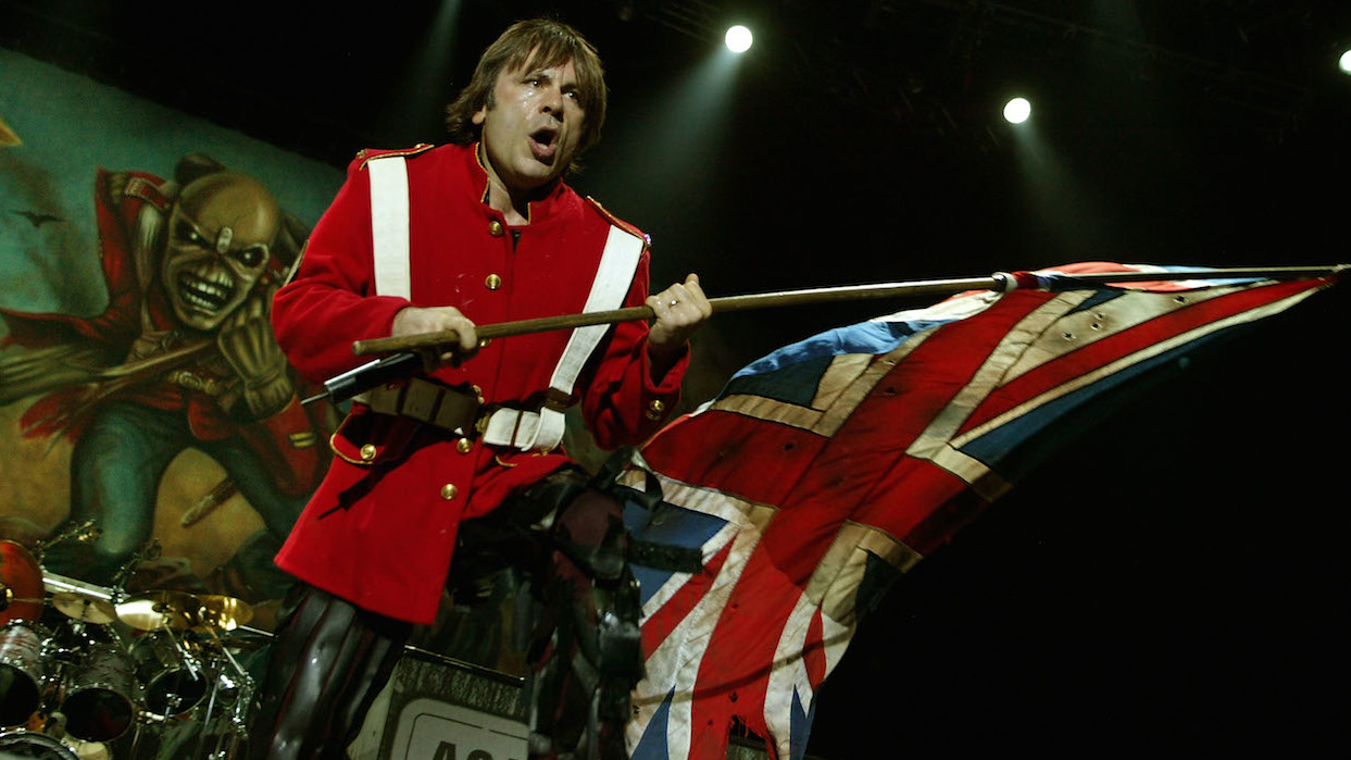 Bruce Dickinson onstage with a British flag