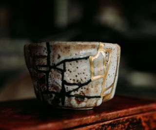 A small cup with gold mending lines