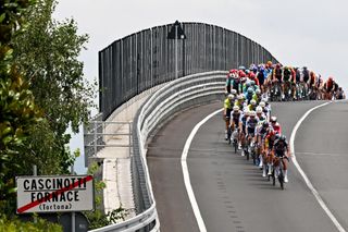 TORINO ITALY JULY 01 A general view of Silvan Dillier of Switzerland and Team Alpecin Deceuninck leads the peloton passing through a Cascinotti Fornace Tortona village during the 111th Tour de France 2024 Stage 3 a 2308km stage from Piacenza to Torino UCIWT on July 01 2024 in Torino Italy Photo by Tim de WaeleGetty Images