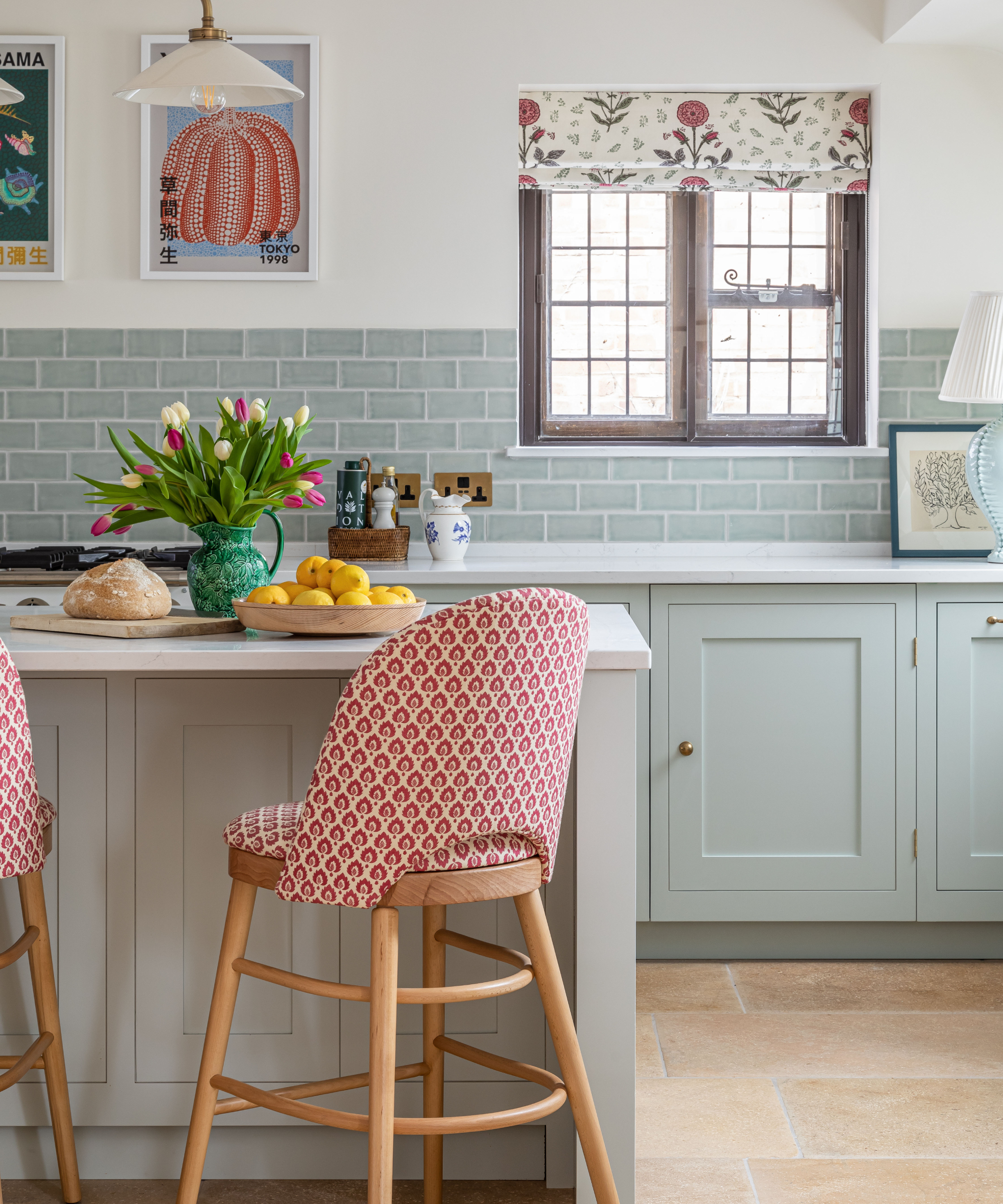 red patterned barstool with wooden legs in sage green country style kitchen