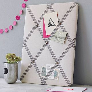 Grey and white Gingham Ribbon Memo Notice board leaning against grey wall