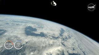 A screenshot of a live stream showing the Dragon capsule in orbit around Earth