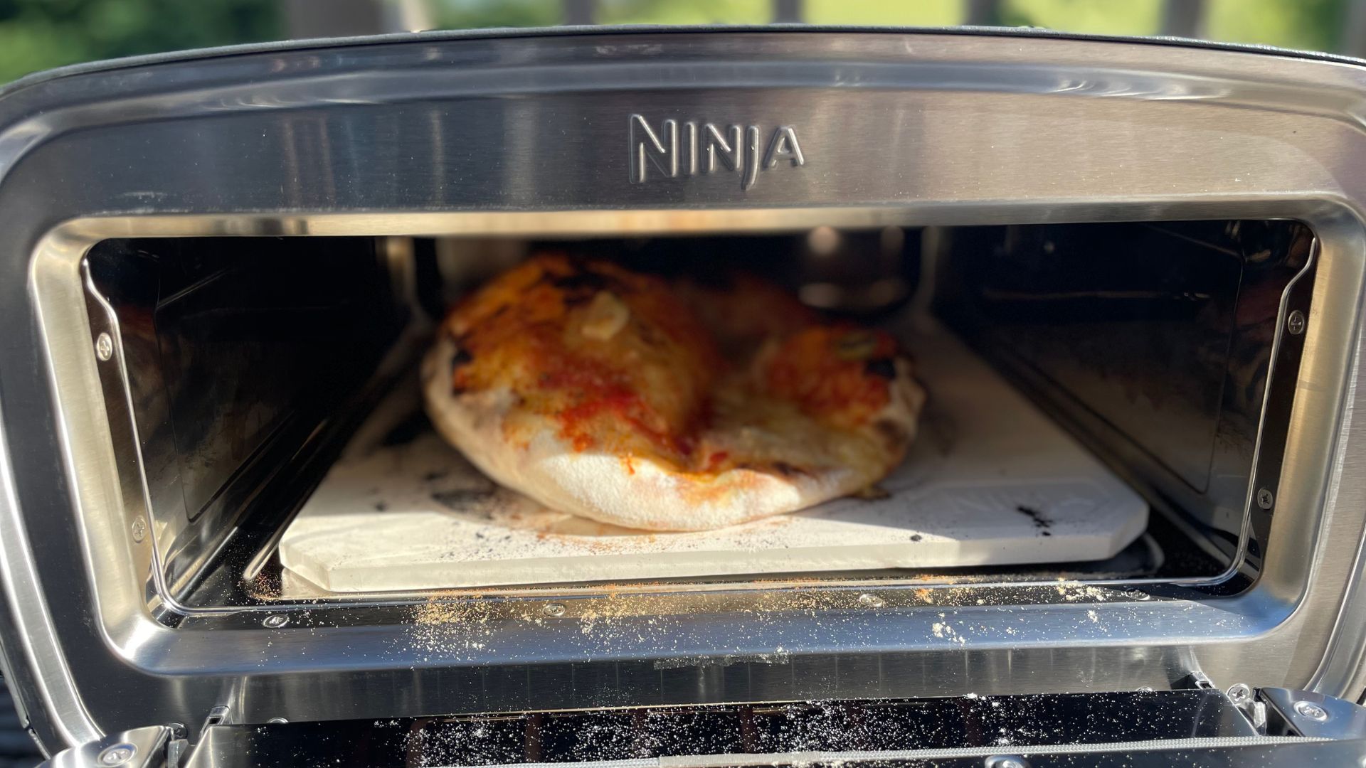 Pizza cooked in the Ninja Artisan Electric Outdoor Pizza Oven and Air Fryer