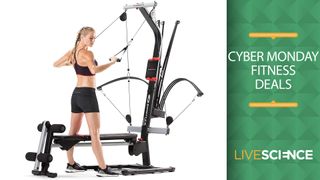 Cyber Monday Bowflex deals. Here, an image of a woman working out on a Bowflex home gym.