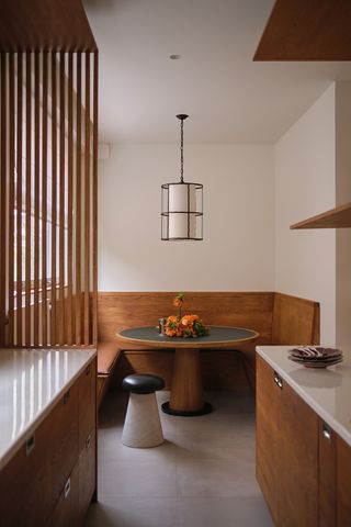modern minimalist kitchen with built in banquette seating and wood slat partitions