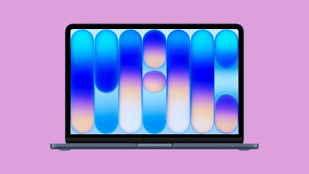 The Apple MacBook Neo, on a pink background. 