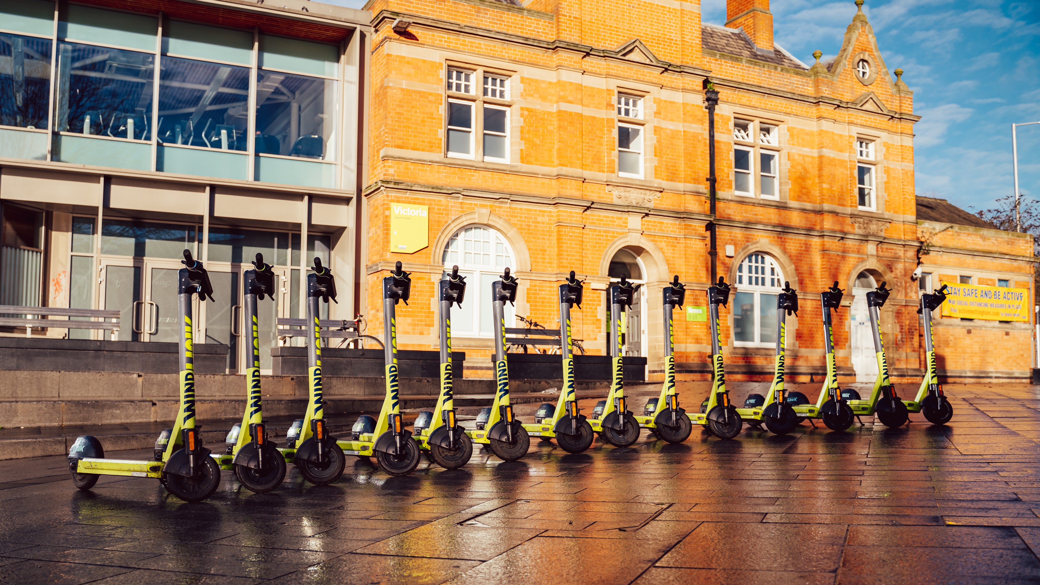 14 Superpedestrian LINK e-scooters standing in a row